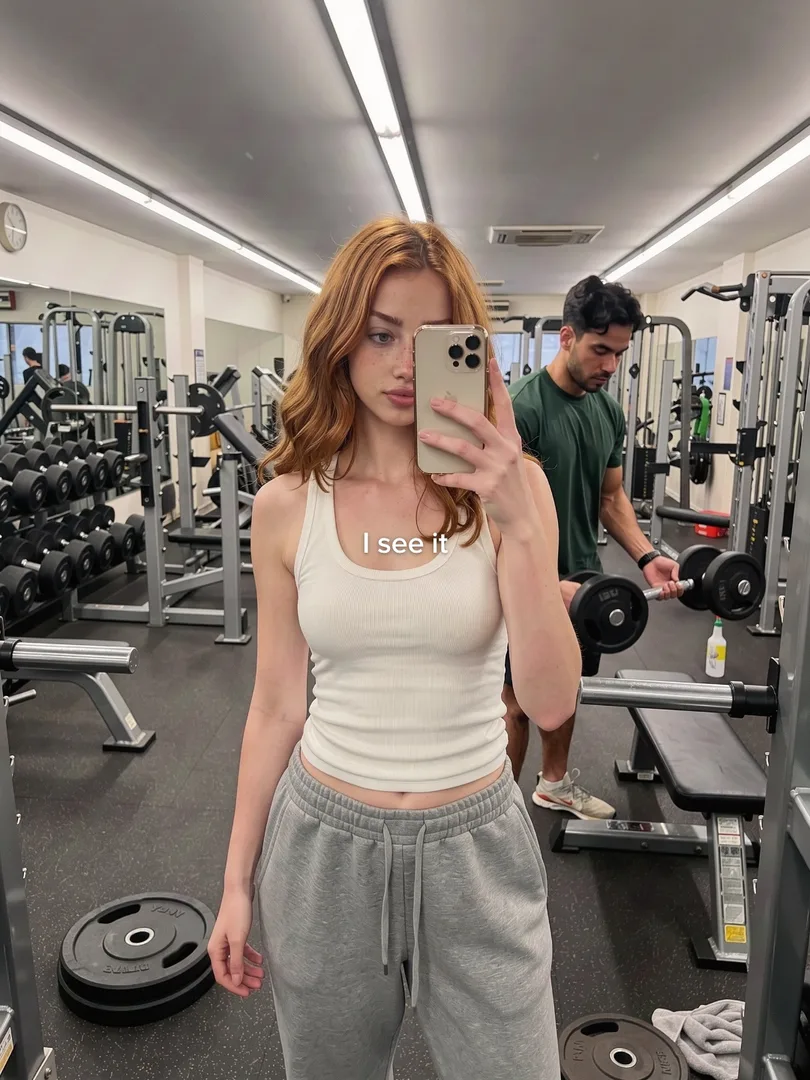 Remake slide 1: a red-haired woman's gym mirror selfie, a man lifting weights behind her, text I see it