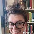 The persona's profile photo: a woman with glasses and her hair up