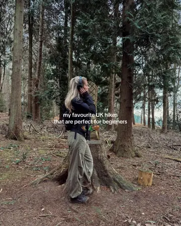 Hiker small in a forest with tiny text about UK hikes
