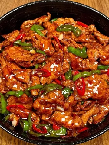 Plate of glazed chicken and peppers, no text