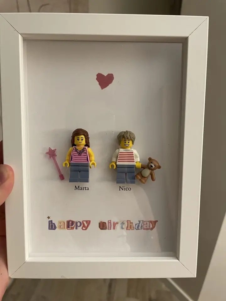 Slide 7: a white frame with two toy figures, a red heart and the words happy birthday