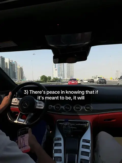 From a driver's seat on a highway, a hand holding a phone, a quote written over the windscreen