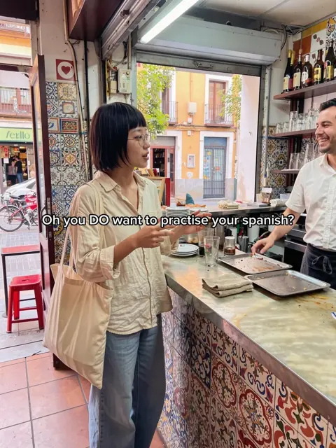 Slide 5: the creator ordering at a sunny Spanish café