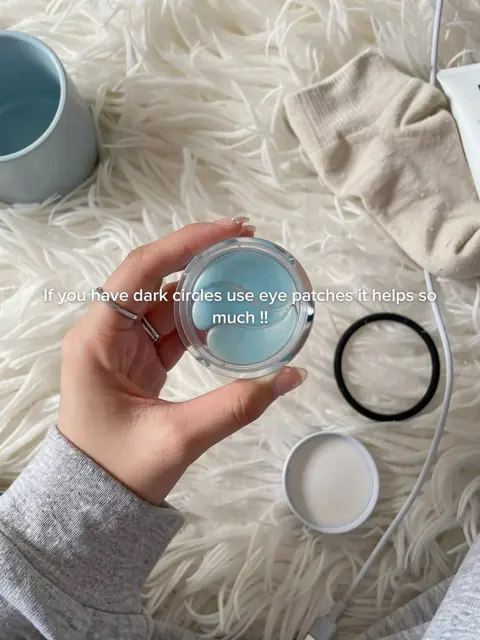Slide 5: holding eye patches over a fluffy rug, for dark circles